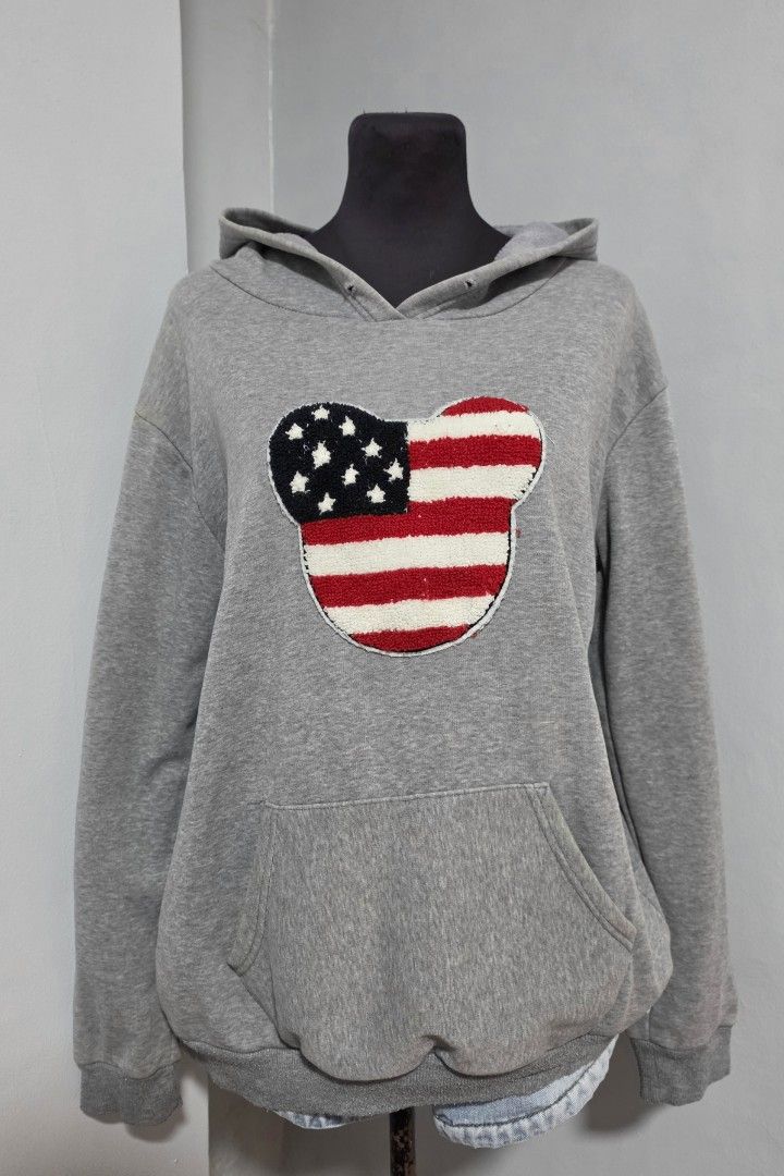 Grey Hoodie American Flag Mickey Mouse Patch Pocket (Category: Coats, Jackets and Outerwear) located in Paranaque City. Submitted by franinnashop (Listing ID 1466622363, Image 1). Description: DECLUTTER LARGE TO XL ISSUE LAST PHOTO AND WALA NA UNG STRING SA HOOD PARANAQUE CITY -Grey pullover hoodie with a prominent embroidered American flag Mickey Mouse patch on the chest. Classic front kangaroo pocket, ribbed cuffs and hem. Relaxed, comfortable 