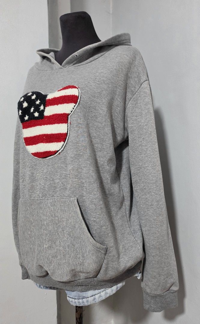 Grey Hoodie American Flag Mickey Mouse Patch Pocket (Category: Coats, Jackets and Outerwear) located in Paranaque City. Submitted by franinnashop (Listing ID 1466622363, Image 3). Description: DECLUTTER LARGE TO XL ISSUE LAST PHOTO AND WALA NA UNG STRING SA HOOD PARANAQUE CITY -Grey pullover hoodie with a prominent embroidered American flag Mickey Mouse patch on the chest. Classic front kangaroo pocket, ribbed cuffs and hem. Relaxed, comfortable 