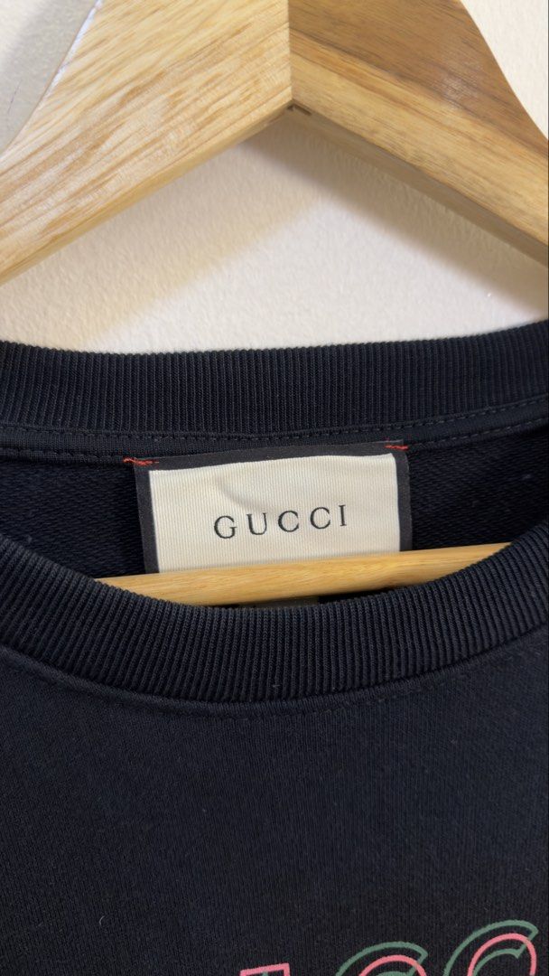Gucci Black Sweatshirt with Pink Logo (Category: Coats, Jackets and Outerwear) located in Paranaque City. Submitted by preluxeshop_ph (Listing ID 1466765939, Image 3). Description: Gucci Black Sweatshirt with Pink Logo -Features iconic pink Gucci logo on front -Condition: 9.8/10 -Dimes: Length: 26” Width: 23”.