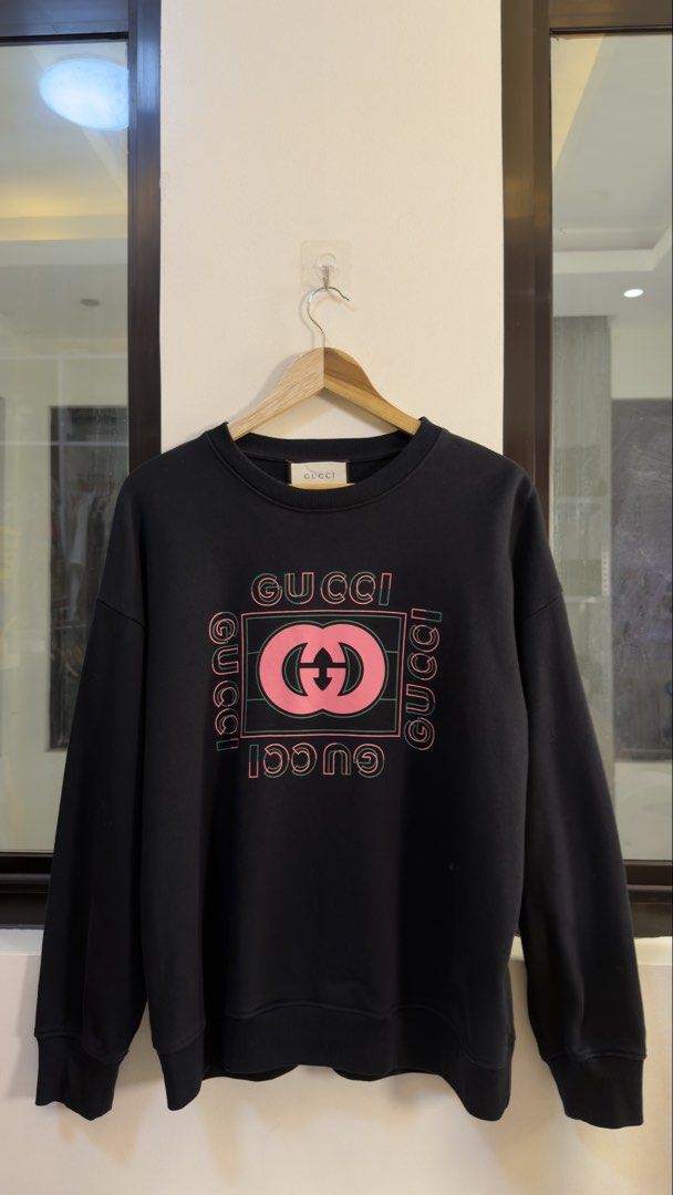 Gucci Black Sweatshirt with Pink Logo (Category: Coats, Jackets and Outerwear) located in Paranaque City. Submitted by preluxeshop_ph (Listing ID 1466765939, Image 2). Description: Gucci Black Sweatshirt with Pink Logo -Features iconic pink Gucci logo on front -Condition: 9.8/10 -Dimes: Length: 26” Width: 23”.