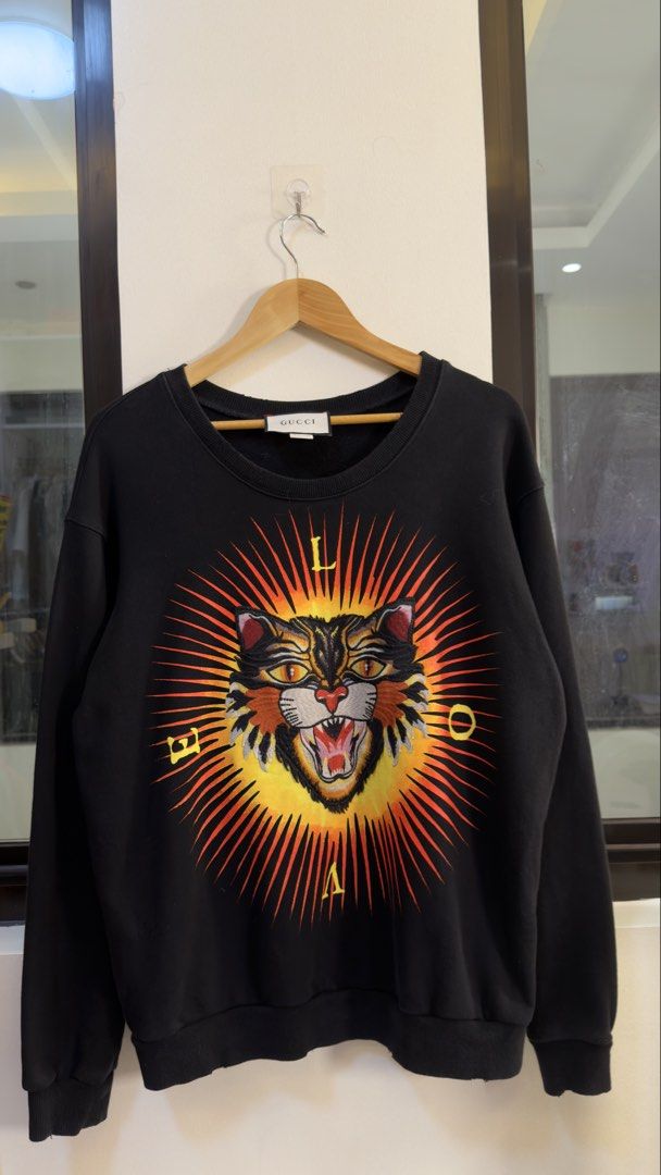 Gucci Black Tiger Print Sweatshirt (Category: Coats, Jackets and Outerwear) located in Paranaque City. Submitted by preluxeshop_ph (Listing ID 1466769216, Image 2). Description: Gucci Black Tiger Print Sweatshirt -Features a bold front tiger graphic -‘MODERN’ and ‘FUTURE’ text on the back -Condition: 9.8/10 -Dimes: Length: 24” Width: 22”.