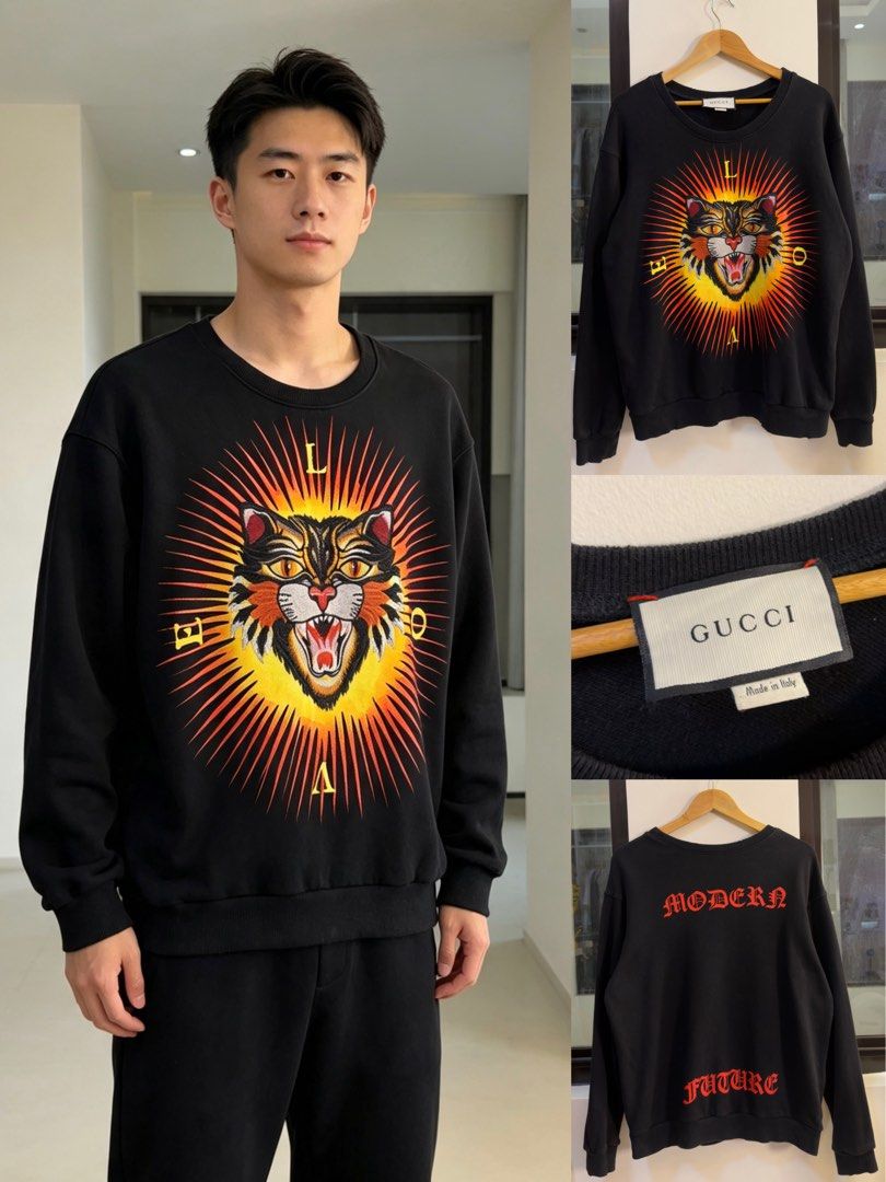 Gucci Black Tiger Print Sweatshirt (Category: Coats, Jackets and Outerwear) located in Paranaque City. Submitted by preluxeshop_ph (Listing ID 1466769216, Image 1). Description: Gucci Black Tiger Print Sweatshirt -Features a bold front tiger graphic -‘MODERN’ and ‘FUTURE’ text on the back -Condition: 9.8/10 -Dimes: Length: 24” Width: 22”.