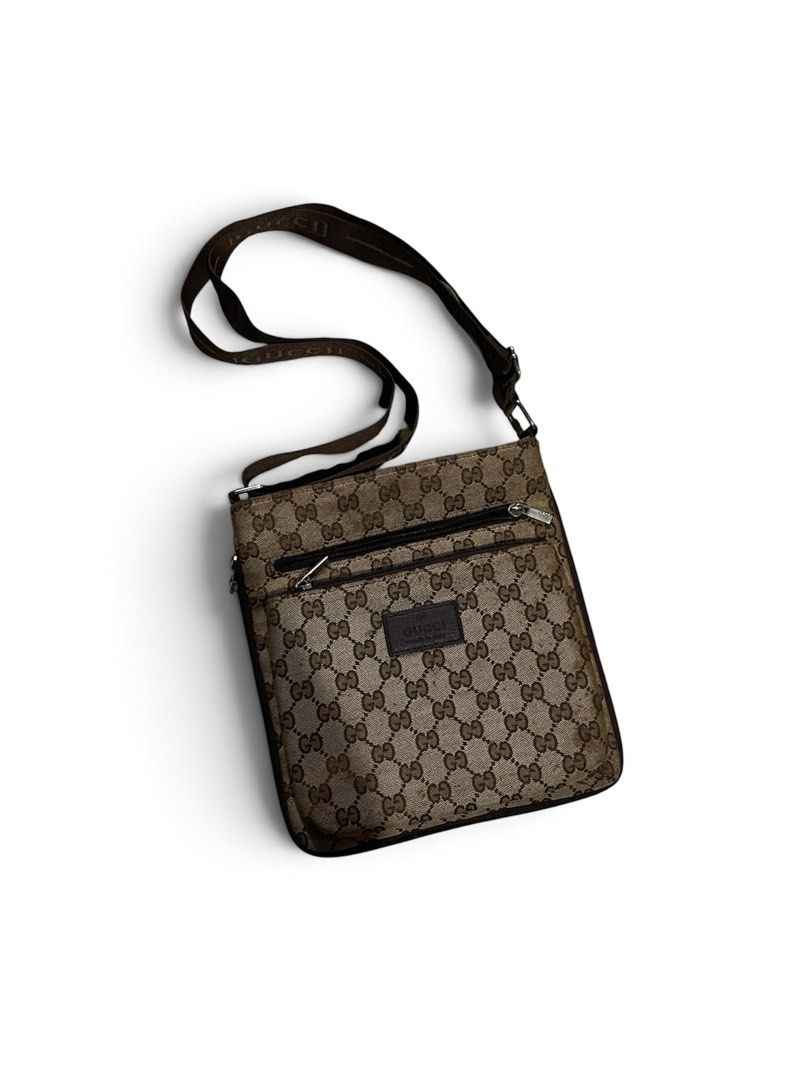 Gucci Monogram Crossbody Bag Brown (Category: Luxury Bags & Wallets) located in M'Lang. Submitted by thrift_finds2 (Listing ID 1466177288, Image 1). Description: - Authentic Gucci monogram crossbody bag in brown canvas and leather - Features iconic repeating GG pattern and branded brown fabric strap - Secure main top zipper closure with convenient front zippered pocket - Interior lined in black with official Gucci leather stamp patch - Perfect ha
