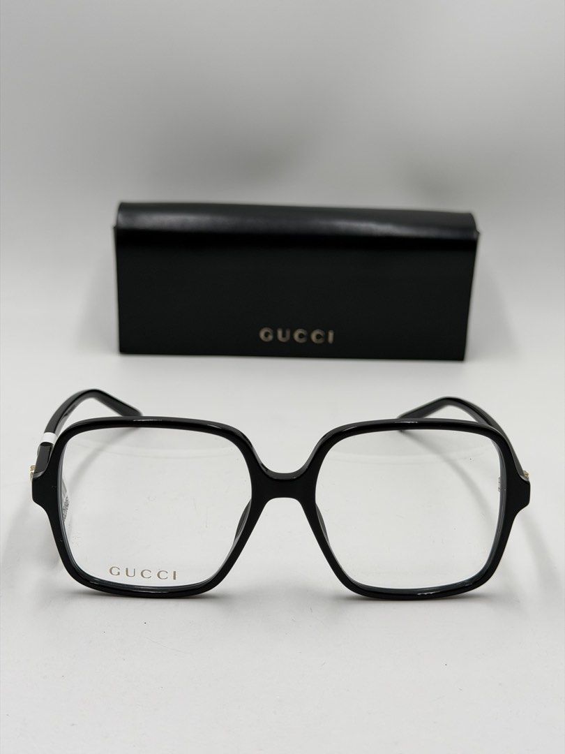 Gucci square-frame eyeglasses GG1003O (Category: Luxury Accessories) located in Lipa City. Submitted by _cmluxephilippines (Listing ID 1466581126, Image 2). Description: GG1003O •Brand: Gucci • Color Code: 001 (Shiny Black) • Measurements: 53/16/140 (53mm Lens Width, 16mm Bridge Width, 140mm Temple Length) • Material: Premium acetate construction featuring the signature interlocking gold-toned GG logo emblem on the temples.