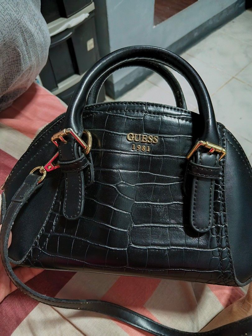 Guess 1981 Black Crocodile Pattern Handbag (Category: Shoulder Bags) located in Quezon City. Submitted by matcarla (Listing ID 1466721622, Image 1). Description: - Brand: Guess 1981 - Color: Classic Black with a chic crocodile texture finish - Hardware: Elegant gold-tone accents, including front logo and strap rings - Straps: Dual top handles plus a convenient detachable shoulder strap - Interior: Stylish patterned fabric lining with a secure zip