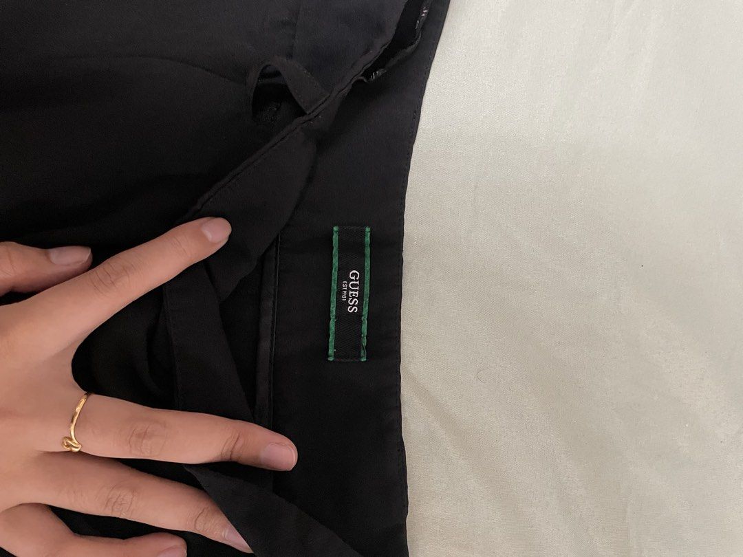 Guess Black Tailored Shorts (Category: Shorts) located in Davao. Submitted by keshichua (Listing ID 1466745961, Image 2). Description: - Brand: Guess - Color: Solid black - Style: Classic tailored shorts with belt loops - Details: Two back welt pockets with silver Guess logo plaque on the right, green inner brand tag - Condition: Great basic piece for dressing up or keeping it casual.