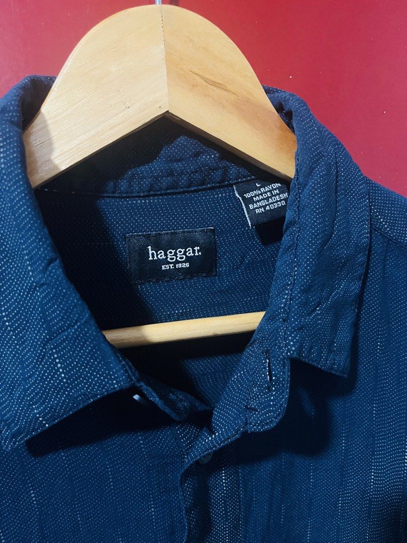 Haggar Men’s Polo (Category: Formal Shirts) located in Quezon City. Submitted by wacpon_061972 (Listing ID 1466683593, Image 1). Description: The image shows a dark blue short-sleeve button-up shirt by Haggar featuring a subtle textured or patterned weave and a single chest pocket..
