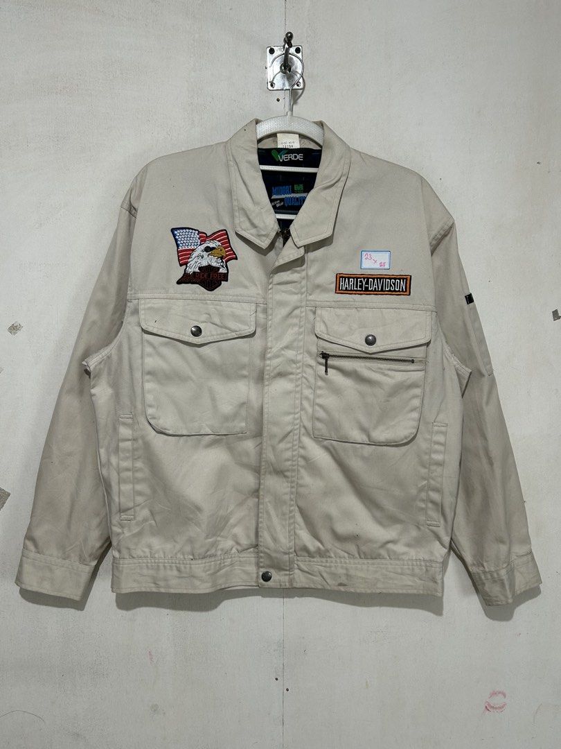 Harley-Davidson Beige Work Jacket with Eagle Patch (Category: Coats, Jackets and Outerwear) located in Mandaluyong City. Submitted by 0lg2026 (Listing ID 1466751378, Image 1). Description: - Color: Classic beige - Material: Sturdy, durable cotton - Branding: Harley-Davidson chest lettering patch - Detail: American flag eagle patch on the right pocket - Storage: Multiple front snap-button pockets and a secure zippered compartment - Design: Classic