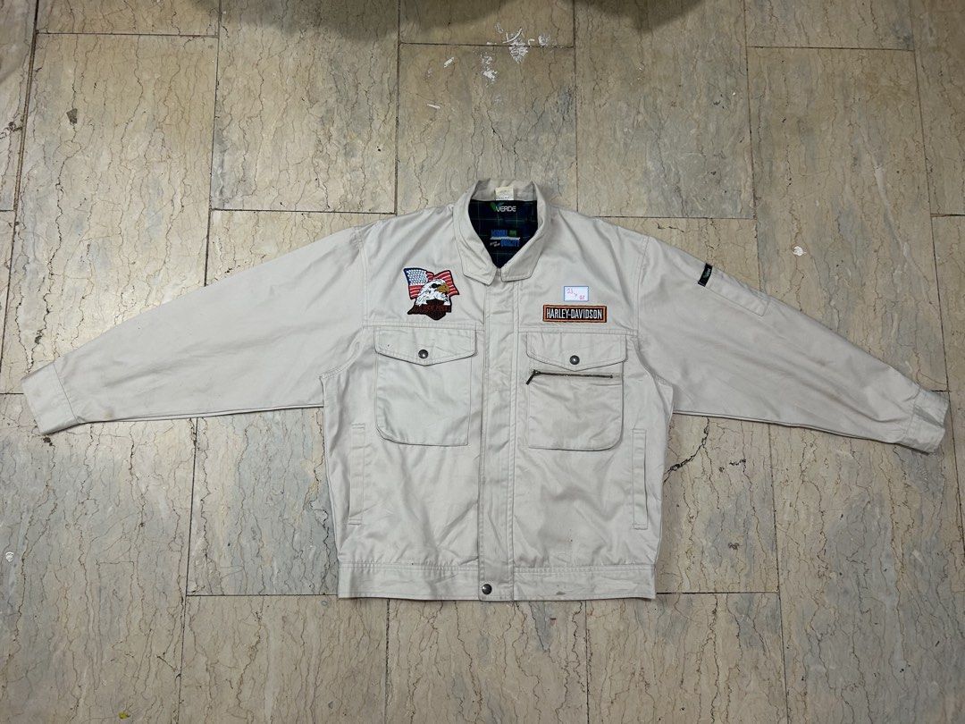 Harley-Davidson Beige Work Jacket with Eagle Patch (Category: Coats, Jackets and Outerwear) located in Mandaluyong City. Submitted by 0lg2026 (Listing ID 1466751378, Image 2). Description: - Color: Classic beige - Material: Sturdy, durable cotton - Branding: Harley-Davidson chest lettering patch - Detail: American flag eagle patch on the right pocket - Storage: Multiple front snap-button pockets and a secure zippered compartment - Design: Classic