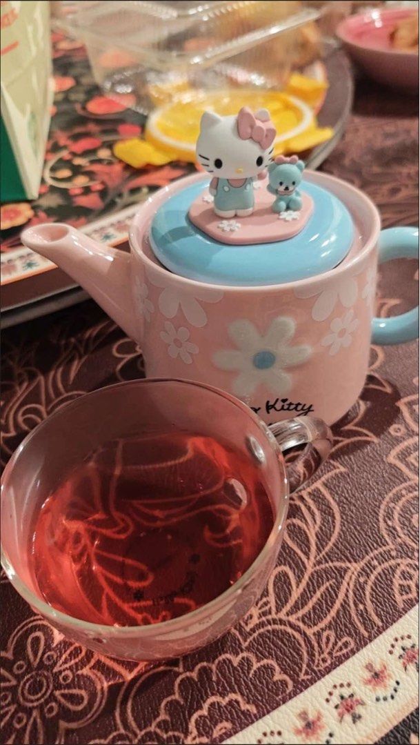 Hello Kitty Ceramic Tea Pot With Glass Cup (Category: Coffee & Tea Tableware) located in Manila. Submitted by janetecson05 (Listing ID 1466650477, Image 1). Description: - Authentic Kitty ceramic tea pot set with a matching glass cup - Adorable pastel pink and blue design featuring a 3D Kitty and cute bear on the lid - Beautiful floral patterns printed across the pot body - Comes with its original box, great for gifting or display - Perfect addit