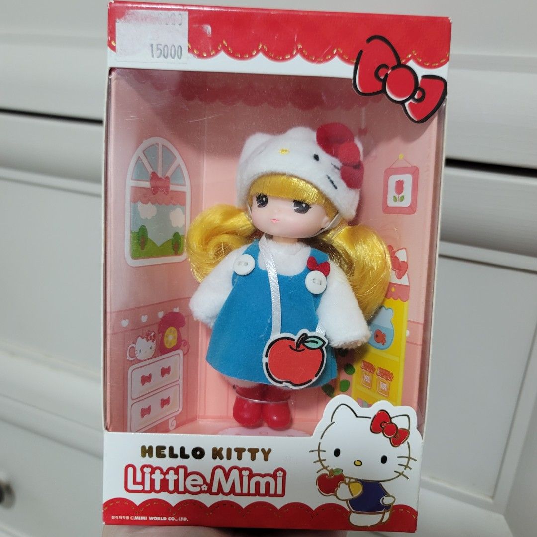 Hello Kitty Little Mimi Doll Sanrio Licensed (Category: Plushies & Soft Toys) located in Pasig City. Submitted by bunny.bella (Listing ID 1466712895, Image 1). Description: - Authentic Kitty Little Mimi doll by Mimi World - Features cute blonde hair, Kitty hat, blue dress with apple design, and red boots - Comes in original box packaging with official Sanrio license - Suitable for ages 37 months and up - Condition: Brand new in box with a small s