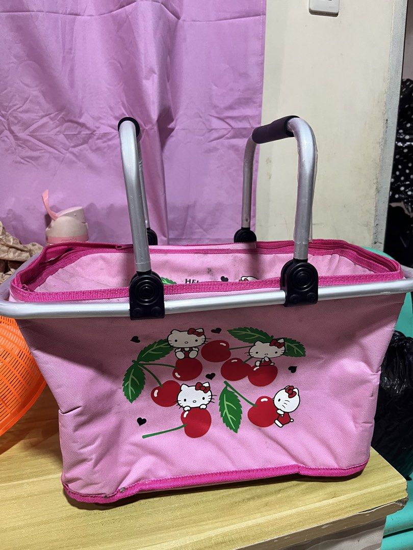 Hello Kitty Pink Picnic Basket Cooler Bag (Category: Shoulder Bags) located in Manila. Submitted by janetecson05 (Listing ID 1466649761, Image 1). Description: - Adorable pink Kitty design with playful cherry print - Sturdy aluminum frame with comfortable black grip handles - Built-in silver thermal insulation lining to keep food and drinks hot or cold - Versatile use for picnics, grocery shopping, or market runs - Conveniently folds flat when no