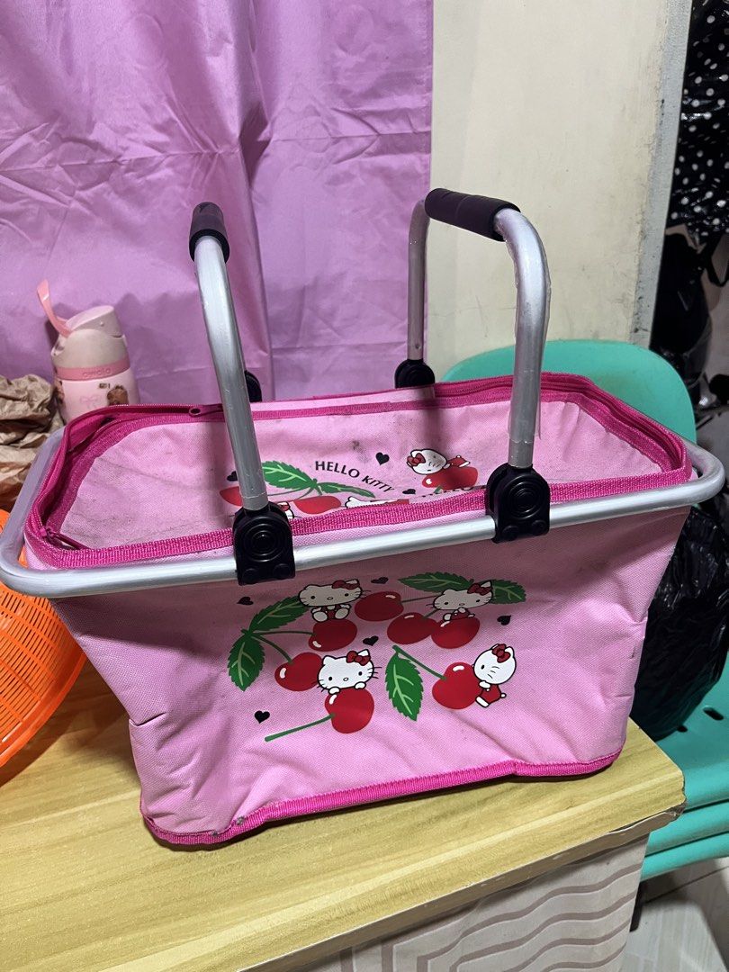 Hello Kitty Pink Picnic Basket Cooler Bag (Category: Shoulder Bags) located in Manila. Submitted by janetecson05 (Listing ID 1466649761, Image 2). Description: - Adorable pink Kitty design with playful cherry print - Sturdy aluminum frame with comfortable black grip handles - Built-in silver thermal insulation lining to keep food and drinks hot or cold - Versatile use for picnics, grocery shopping, or market runs - Conveniently folds flat when no