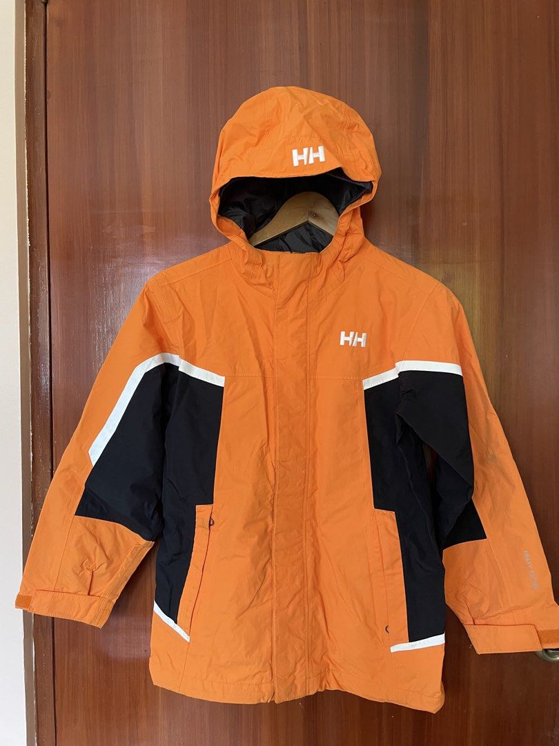 Helly Hansen Orange Black Waterproof Hooded Jacket Size M (Category: Coats, Jackets and Outerwear) located in Cebu City. Submitted by annyeongthriftcebu (Listing ID 1466633923, Image 1). Description: - Brand: Helly Hansen - Color: Bright orange with black and white color blocking - Branding: Bold white HH printed on hood, chest, and back - Features: Zippered front closure with storm flap, high collar, front hand pockets, and gray inner lining - C