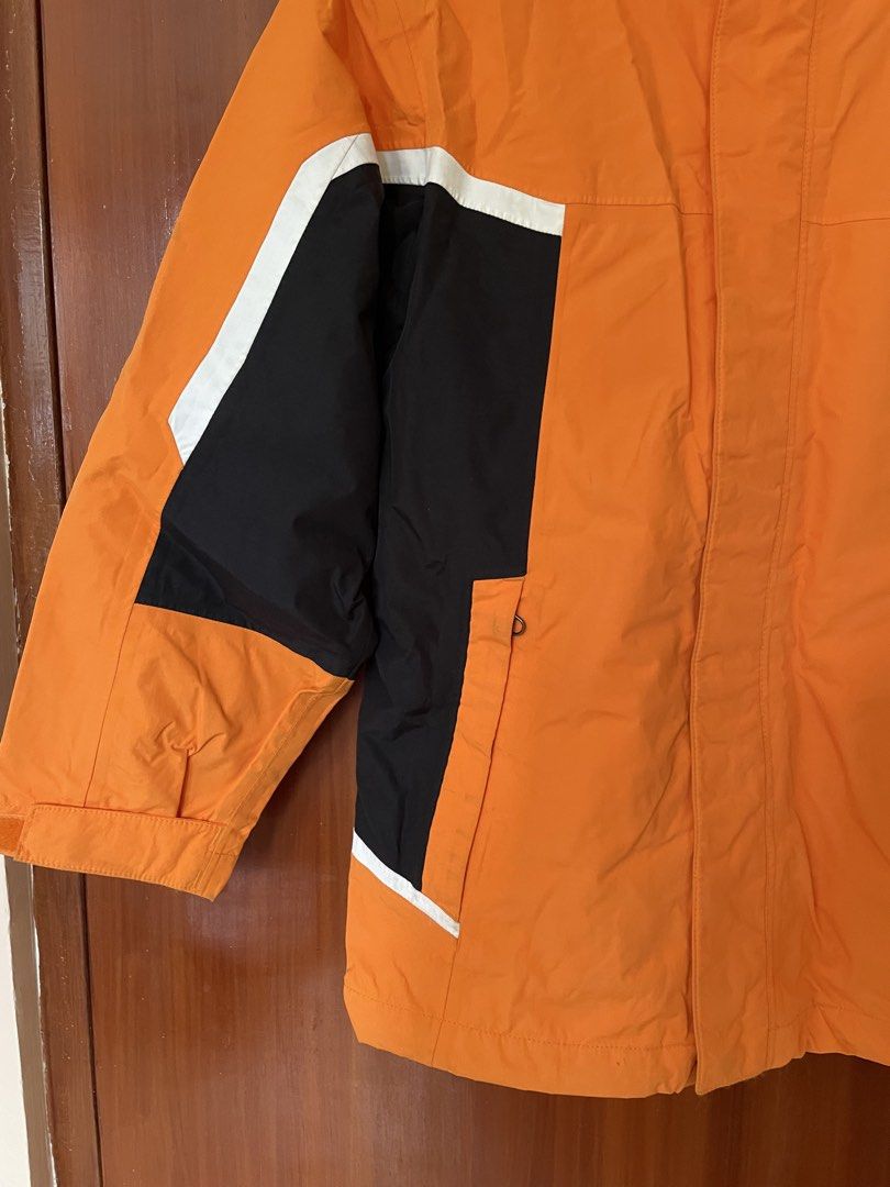 Helly Hansen Orange Black Waterproof Hooded Jacket Size M (Category: Coats, Jackets and Outerwear) located in Cebu City. Submitted by annyeongthriftcebu (Listing ID 1466633923, Image 3). Description: - Brand: Helly Hansen - Color: Bright orange with black and white color blocking - Branding: Bold white HH printed on hood, chest, and back - Features: Zippered front closure with storm flap, high collar, front hand pockets, and gray inner lining - C
