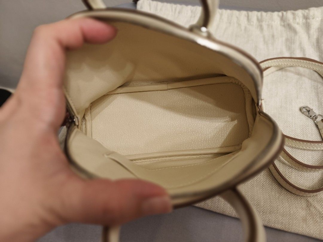 Hermès Bolide Mini Off-White Leather Bag (Category: Luxury Bags & Wallets) located in Antipolo. Submitted by jarazote (Listing ID 1466660464, Image 3). Description: - Authentic leather bag - Color: Off-white textured leather with rich brown piping - Hardware: Polished silver-tone - Handles & Strap: Dual top handles and a removable shoulder strap with contrast edge - Interior: Matching full leather lining with stamped Hermès Paris Made in France l