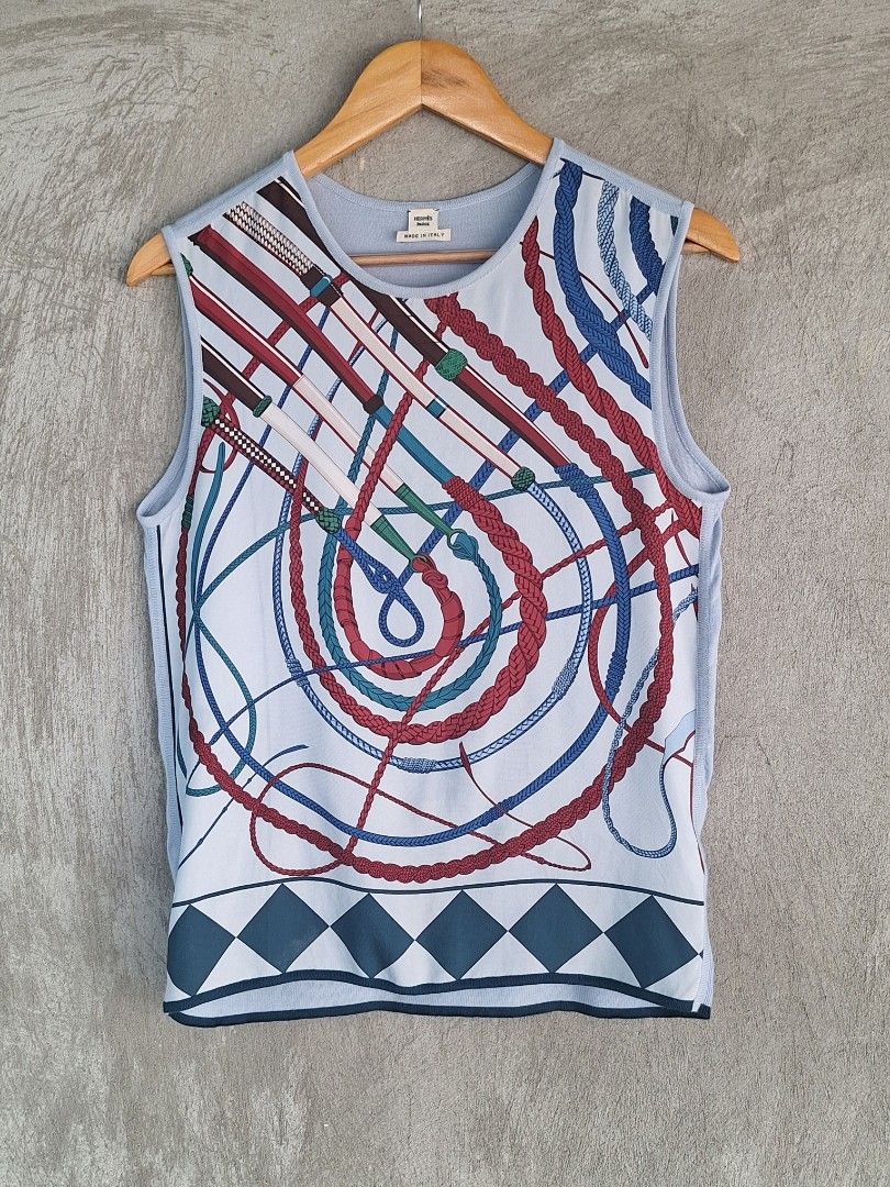 Hermès Paris / Silk Sleeveless Top ( Authentic ) (Category: Sleeveless) located in Cebu City. Submitted by thehiddengemsbykid (Listing ID 1466593391, Image 1). Description: Hermès Paris Sleeveless Top Pale blue with vibrant multi-color silk front and contrasting dark blue hem trim 100% Silk front panel (classic equestrian whip and rope print) Size : 36 Width - 18 Length - 24 Shoulder - 18 Hem - 17 Excellent Condition Flaws : Last 2 pic.Not notisa