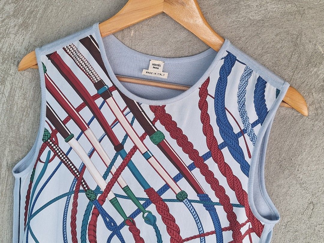 Hermès Paris / Silk Sleeveless Top ( Authentic ) (Category: Sleeveless) located in Cebu City. Submitted by thehiddengemsbykid (Listing ID 1466593391, Image 2). Description: Hermès Paris Sleeveless Top Pale blue with vibrant multi-color silk front and contrasting dark blue hem trim 100% Silk front panel (classic equestrian whip and rope print) Size : 36 Width - 18 Length - 24 Shoulder - 18 Hem - 17 Excellent Condition Flaws : Last 2 pic.Not notisa