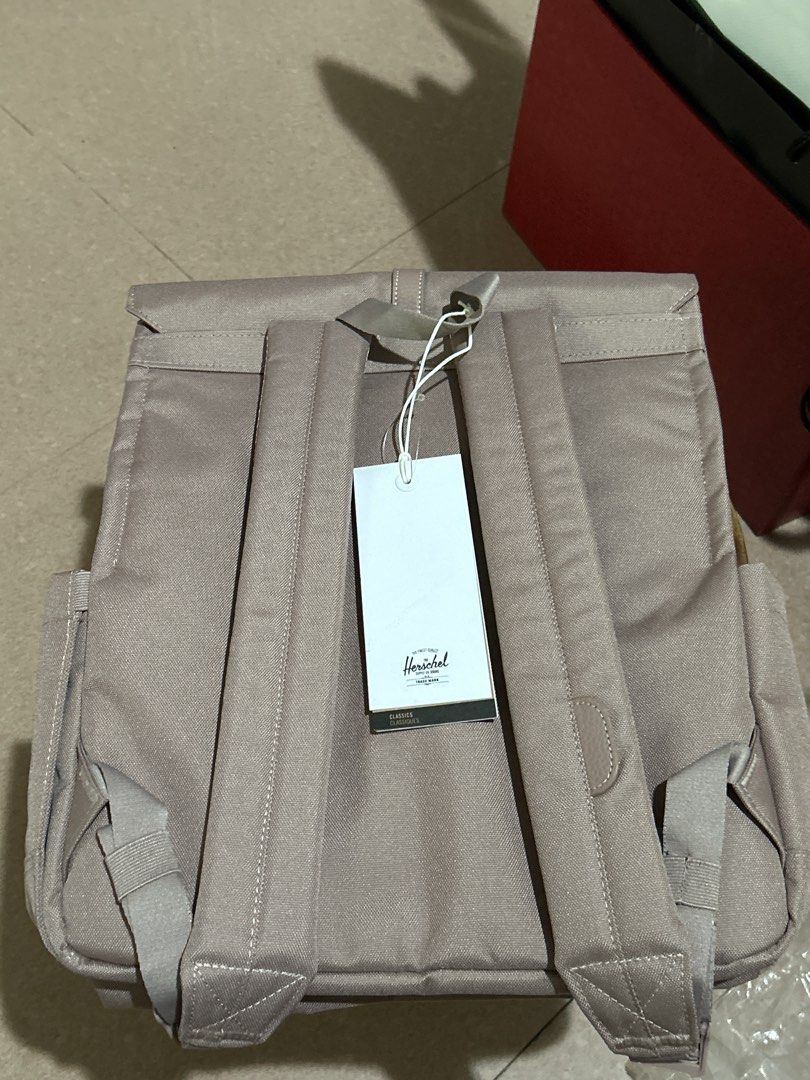 Herschel City Backpack Ash Rose 16L (Category: Backpacks) located in Alitagtag. Submitted by patrickvillanueva (Listing ID 1466618408, Image 2). Description: - Brand: Herschel Supply Co. (City Backpack) - Color: Ash Rose - Condition: Brand new with original tags attached - Capacity: 16 Liters - Dimensions: 14.5" H x 12.75" W x 6" D - Closure: Flap with stylish buckle strap detail - Interior: Fully lined main compartment - Perfect for everyday use