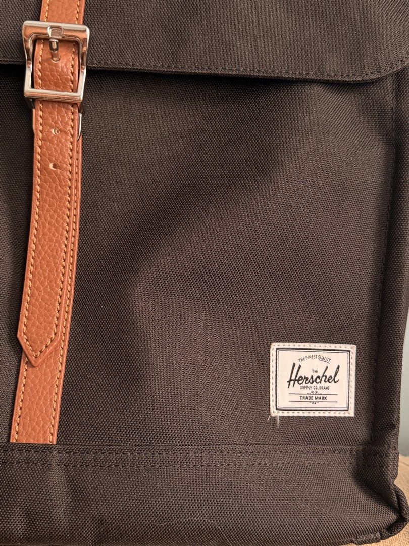 Herschel Supply Co. Dark Brown Backpack with Tan Strap (Category: Backpacks) located in Caloocan City. Submitted by anlzbntng__ (Listing ID 1466649636, Image 3). Description: - Brand: Herschel Supply Co. - Color: Dark Brown with Tan Leather Straps - Material: Clean, durable canvas - Features: Metal buckle closure, classic white woven label, side pockets - Comfort: Adjustable padded black shoulder straps - Condition: Excellent/Clean - Perfect for 