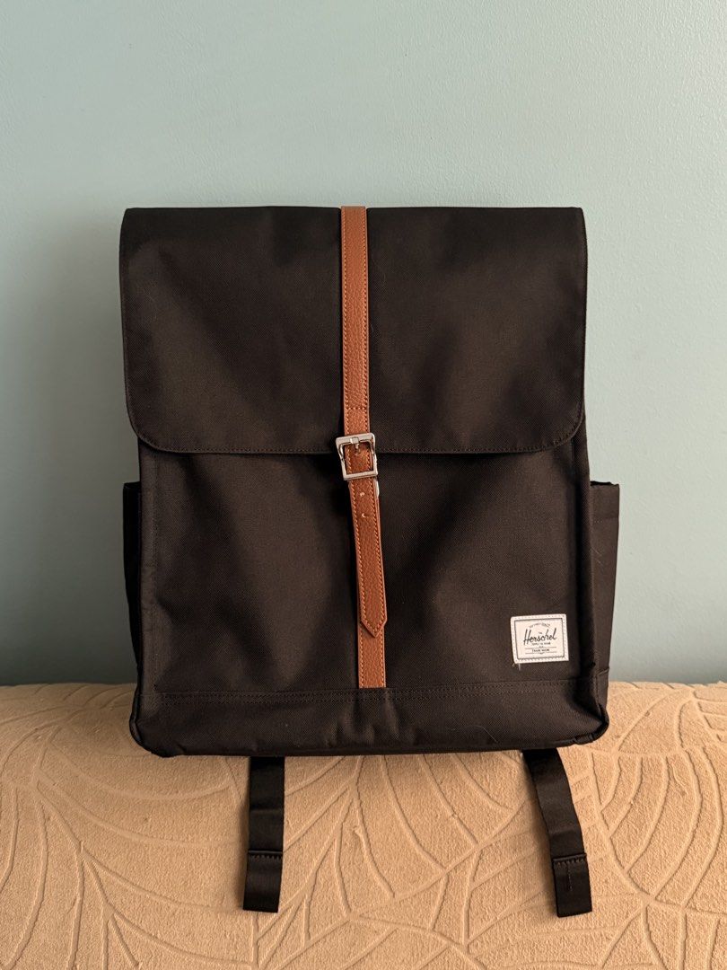 Herschel Supply Co. Dark Brown Backpack with Tan Strap (Category: Backpacks) located in Caloocan City. Submitted by anlzbntng__ (Listing ID 1466649636, Image 1). Description: - Brand: Herschel Supply Co. - Color: Dark Brown with Tan Leather Straps - Material: Clean, durable canvas - Features: Metal buckle closure, classic white woven label, side pockets - Comfort: Adjustable padded black shoulder straps - Condition: Excellent/Clean - Perfect for 