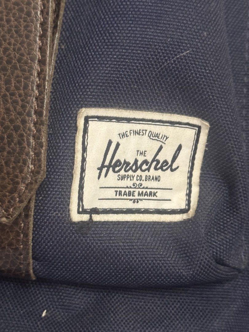 Herschel Supply Co. Navy Blue Backpack with Brown Straps (Category: Backpacks) located in Taguig. Submitted by cln_preloved (Listing ID 1466617988, Image 2). Description: - Brand: Herschel Supply Co. - authentic! Still with the original plastic and cards - rfs: not being used, stuck lang po sa storage Flaws: please see photos! .