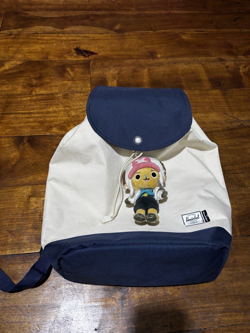 Herschel Supply Co. x Beams Backpack (Category: Backpacks) located in Malaybalay. Submitted by ziggyy. (Listing ID 1466693935, Image 1). Description: - Authentic Herschel Supply Co. x Beams collaboration backpack - Stylish white canvas body with a contrast navy blue base and top flap - Secure drawstring closure with snap button fasteners - Vibrant orange and white striped inner lining with an interior zip pocket - Comfortable adjustable padded sh