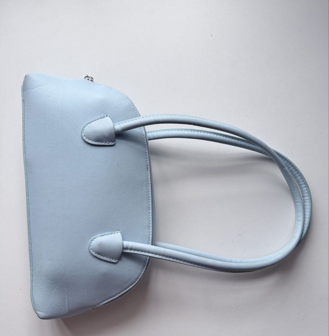 H&M Light Blue Shoulder Bag (Category: Shoulder Bags) located in Makati City. Submitted by withlovekhl (Listing ID 1466717657, Image 2). Description: Small shoulder bag with shoulder straps and a zip at the top. Taffeta lining. Depth 5 cm. Height 13 cm. Width 27 cm. just for decluttering, not for picky ⊹ ࣪ ˖ not open for swapping ty!.