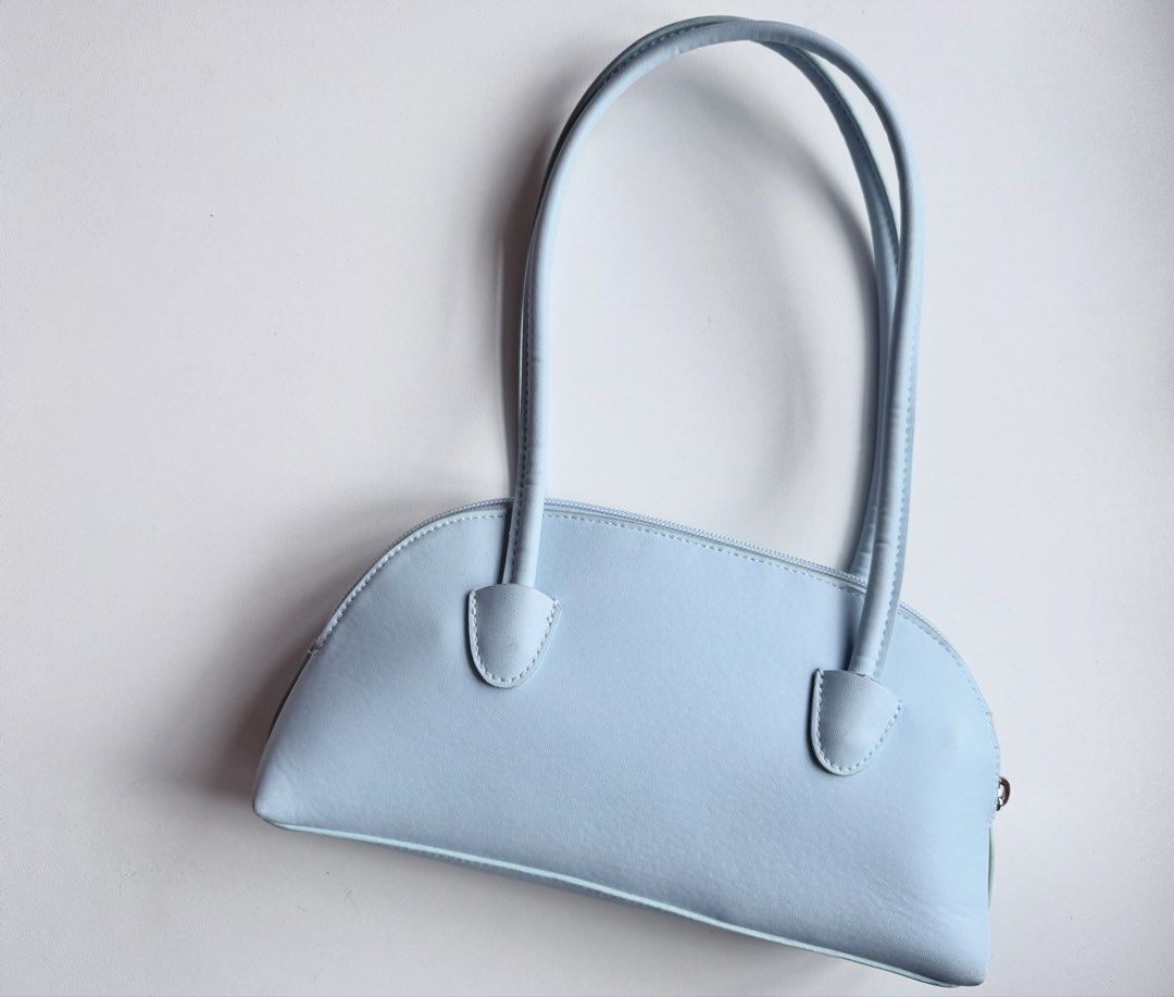 H&M Light Blue Shoulder Bag (Category: Shoulder Bags) located in Makati City. Submitted by withlovekhl (Listing ID 1466717657, Image 1). Description: Small shoulder bag with shoulder straps and a zip at the top. Taffeta lining. Depth 5 cm. Height 13 cm. Width 27 cm. just for decluttering, not for picky ⊹ ࣪ ˖ not open for swapping ty!.