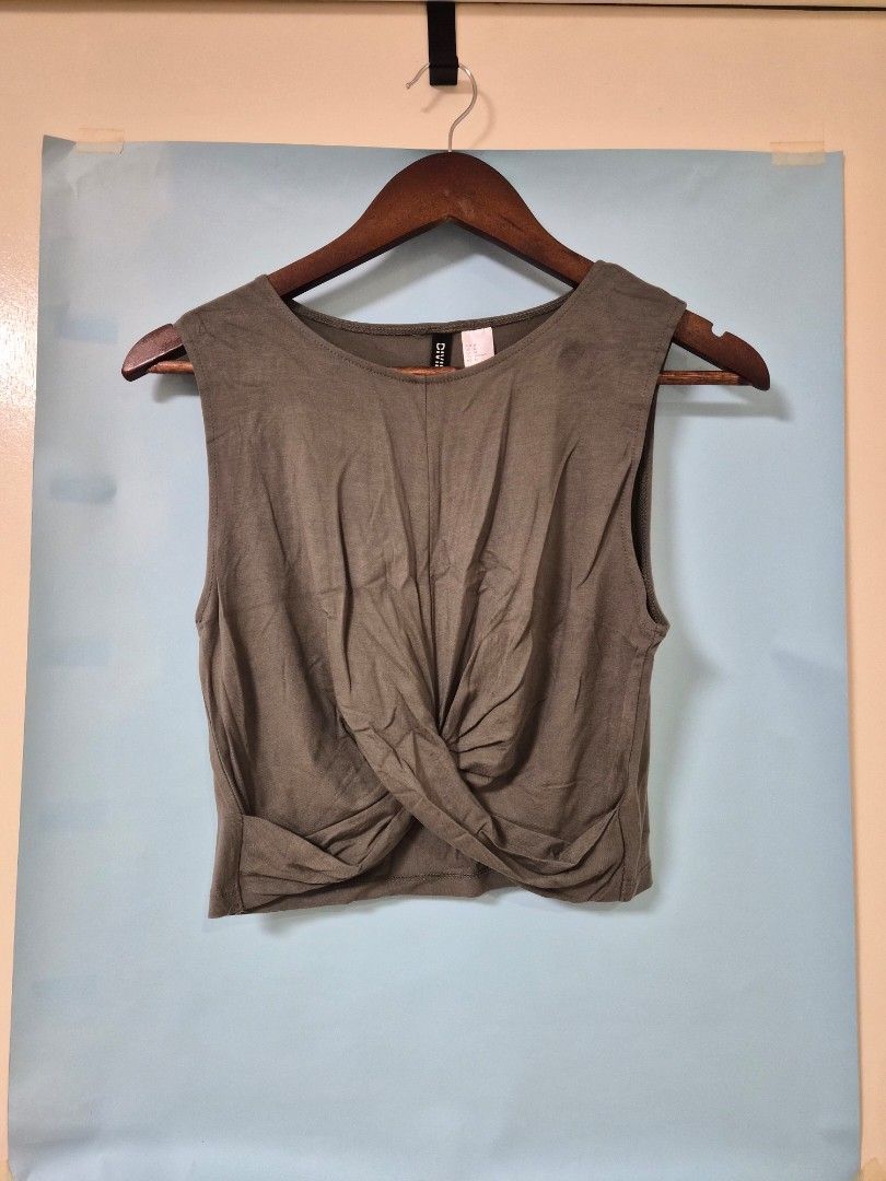 H&M Olive Green Sleeveless Top (Category: Sleeveless) located in Manila. Submitted by prelovedbyc.hannah (Listing ID 1466701765, Image 1). Description: - Brand: Divided by H&M - Size: Medium - Color: Olive Green - Design: Round neckline with a chic twisted front knot - Material: Lightweight, soft, and breathable cotton blend.