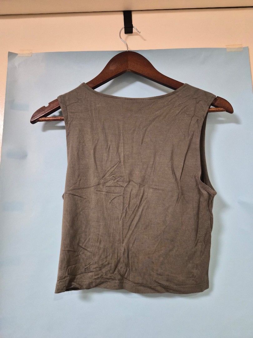 H&M Olive Green Sleeveless Top (Category: Sleeveless) located in Manila. Submitted by prelovedbyc.hannah (Listing ID 1466701765, Image 2). Description: - Brand: Divided by H&M - Size: Medium - Color: Olive Green - Design: Round neckline with a chic twisted front knot - Material: Lightweight, soft, and breathable cotton blend.