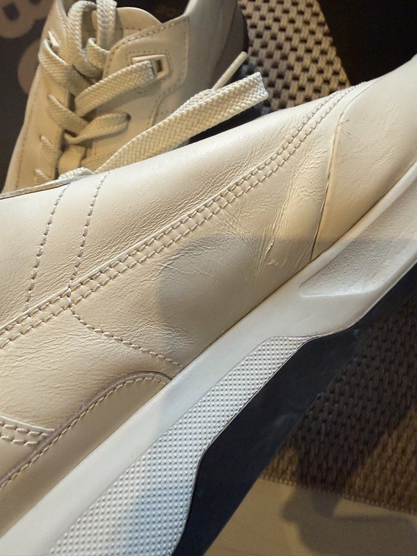 HUGO BOSS Cream White Leather Sneakers (Category: Sneakers) located in Manila. Submitted by shan.rubio (Listing ID 1466644913, Image 3). Description: - Brand: BOSS - Color: Classic Cream White - Material: Premium Leather with chunky rubber sole - Design details: Subtle perforated toe, metal branding plaque on laces, and embossed logo on the side - Inclusion: Original black presentation box - Condition: Minor creasing on the side leather from prev
