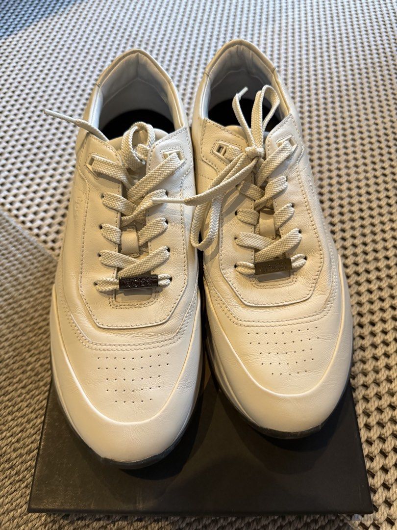 HUGO BOSS Cream White Leather Sneakers (Category: Sneakers) located in Manila. Submitted by shan.rubio (Listing ID 1466644913, Image 1). Description: - Brand: BOSS - Color: Classic Cream White - Material: Premium Leather with chunky rubber sole - Design details: Subtle perforated toe, metal branding plaque on laces, and embossed logo on the side - Inclusion: Original black presentation box - Condition: Minor creasing on the side leather from prev
