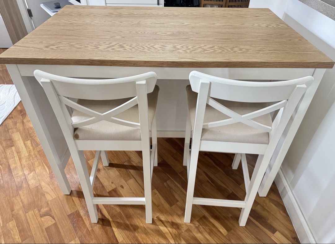 IKEA TONVIKEN Kitchen Island with Bar Stools (Category: Tables & Sets) located in Makati City. Submitted by agatila (Listing ID 1466745290, Image 1). Description: - Brand/Model: IKEA TONVIKEN Kitchen Island with 2 matching bar stools - Design: Modern Scandinavian style with white frame and natural wood-grain top and shelves - Storage: Includes two open shelves at the back for kitchen essentials or decor - Seating: Comes with two sturdy white bar 