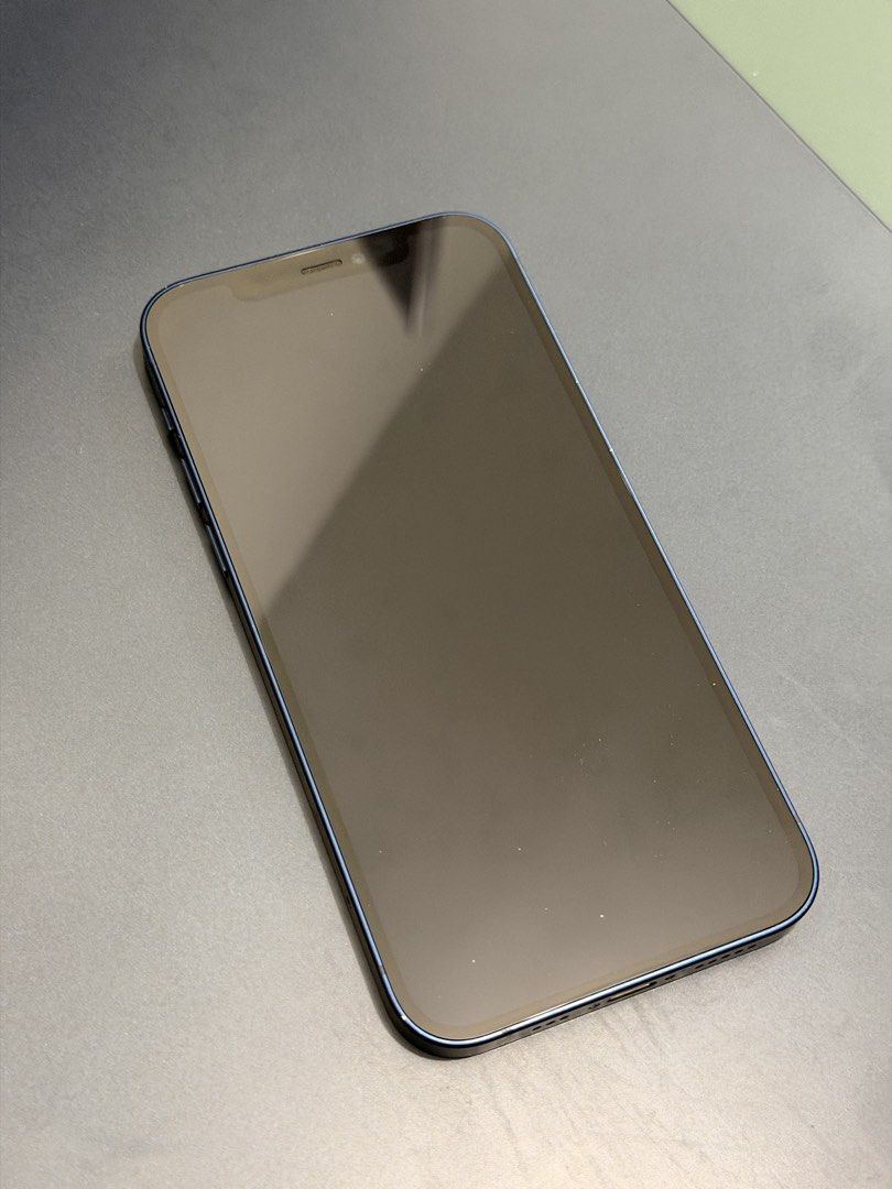 iPhone 12 (Category: iPhone 12 Series) located in Quezon City. Submitted by saveandrave01 (Listing ID 1466729420, Image 2). Description: - Model: Apple iPhone 12 - Color: Blue - Battery Health: 100% - Open line to any sim/e-sim - Condition: Good working condition with minor paint chipping around the camera module (as shown in photos) - Display & Body: Clean screen and sleek blue finish - Meetup Location: SM City North EDSA, Quezon City or Grab/La
