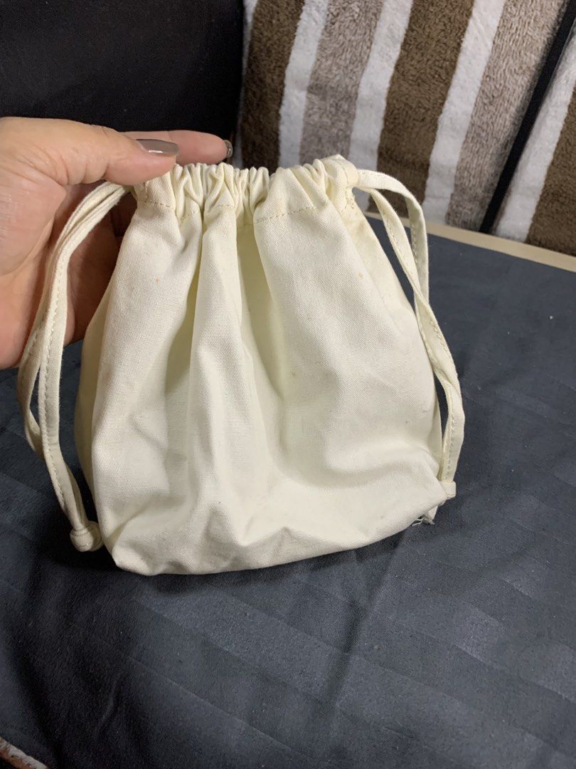 Japan canvas string pouch (Category: Purses & Pouches) located in Cabanatuan. Submitted by mjluxxejapan (Listing ID 1466576082, Image 1). Description: Fixed price approx 7”x7” meas makapal matibay tela need was medyo may dirt lang milky white color .