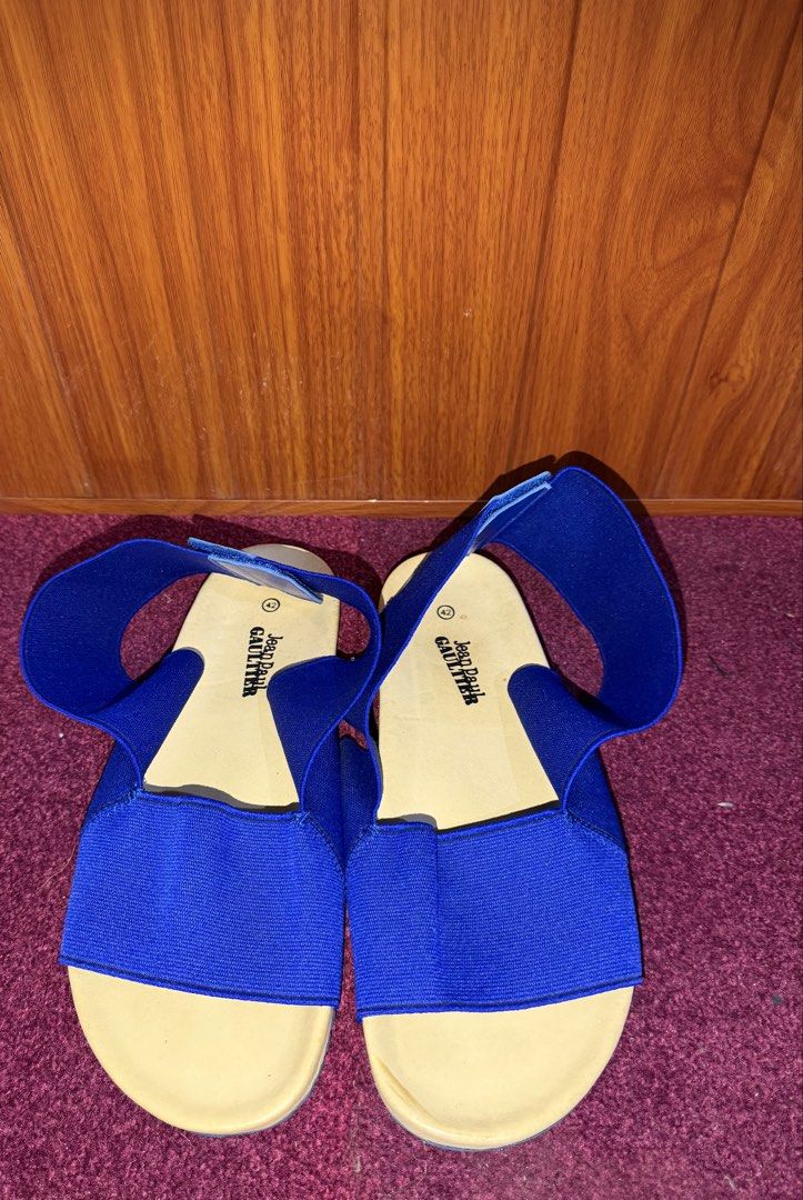 Jean Paul Gaultier Blue Sandals (Category: Flats & Sandals) located in Manila. Submitted by tlfph (Listing ID 1466680454, Image 1). Description: - Brand: Jean Paul Gaultier - Style: Bright blue sandals with secure elastic straps - Size: EU 42 - Origin: Made in Portugal - Details: Light beige footbed with stamped logo, ridged blue rubber outsoles for extra grip - Condition: Clean with minimal wear on the soles.