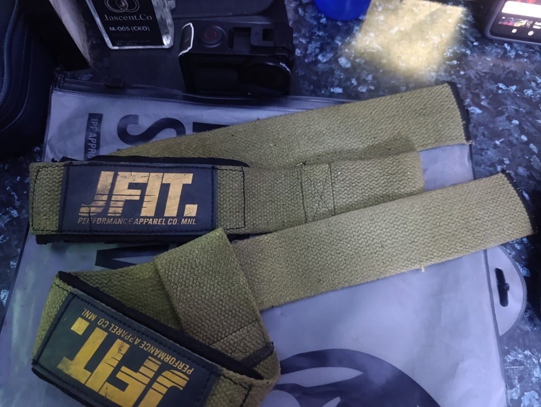 JFIT Performance Apparel Co. MNL Wrist Wraps (Category: Weights & Dumbbells) located in Manila. Submitted by mrjmodina87184 (Listing ID 1466654109, Image 1). Description: - Brand: JFIT - Color: Army green with yellow branding - Material: Heavy-duty cotton with durable edge stitching - Support: Solid wrist support for heavy lifts, powerlifting, and CrossFit - Closure: Secure Velcro closure - Care: Hand-washable.