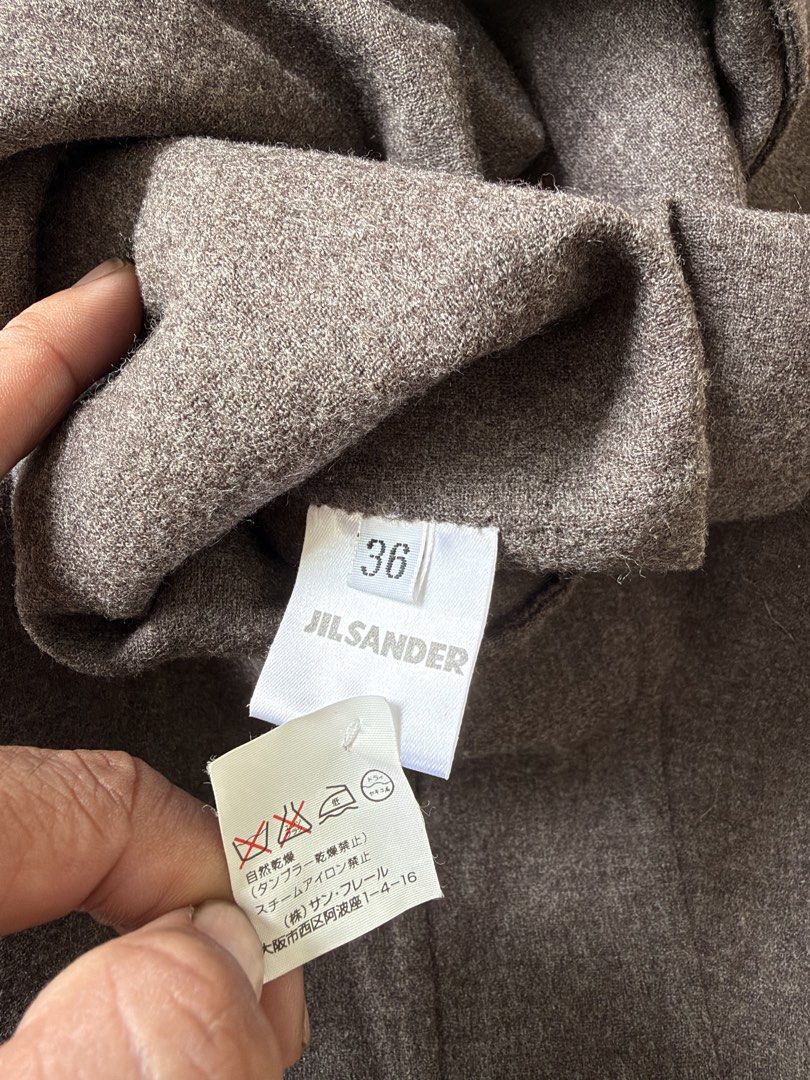 Jil Sander Wool Skirt Brown Size 36 (Category: Skirts) located in Alfonso. Submitted by jbcamet (Listing ID 1466566692, Image 3). Description: - Brand: Jil Sander - Item: Wool midi skirt - Color: Rich brown - Size: Tagged Size 36 - Material: Structured wool - Closure: Side zip - Details: Interior label and care instructions intact - Style: Classic minimalist aesthetic.