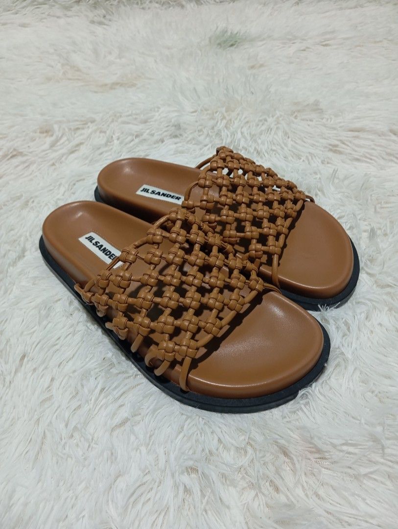 Jil Sander Woven Leather Slides Brown (Category: Sneakers & Footwear) located in Quezon City. Submitted by thesecondmarketph (Listing ID 1466234770, Image 1). Description: - Brand: Jil Sander - Color: Tan brown with black soles - Material: Premium leather with intricate woven strap design - Condition: Like new, properly stored in closet - Features: Open toe, slip-on style, clean footbeds, and branded white insoles - PM for inquiries or fast shipp