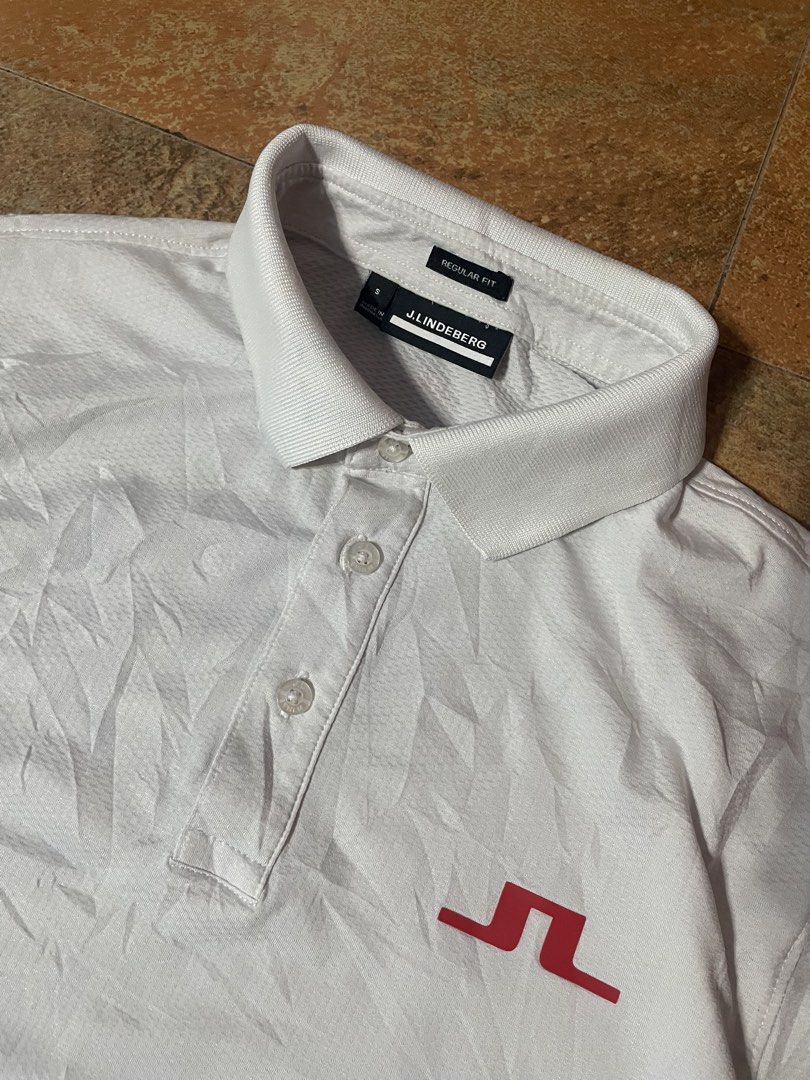 j.lindeberg Regular Fit White Polo Shirt (Category: Tshirts & Polo Shirts ) located in Panabo. Submitted by sales.mad (Listing ID 1466737569, Image 2). Description: - Brand: J.Lindeberg - Style: Regular fit polo shirt - Color: Clean white with a small red embroidered chest logo - Features: Classic collar, button placket, and breathable textured fabric - Size: Small (tag and interior neck labels intact) -21x28 dimension - Condition: Excellent, rea