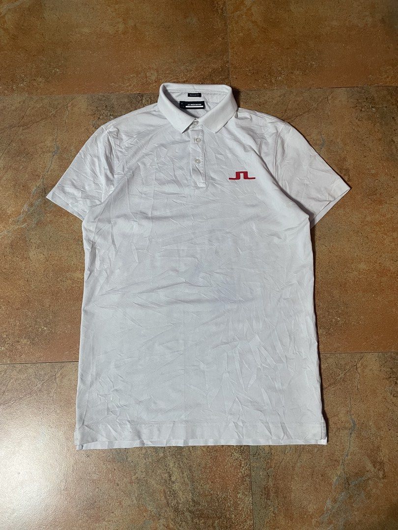 j.lindeberg Regular Fit White Polo Shirt (Category: Tshirts & Polo Shirts ) located in Panabo. Submitted by sales.mad (Listing ID 1466737569, Image 1). Description: - Brand: J.Lindeberg - Style: Regular fit polo shirt - Color: Clean white with a small red embroidered chest logo - Features: Classic collar, button placket, and breathable textured fabric - Size: Small (tag and interior neck labels intact) -21x28 dimension - Condition: Excellent, rea