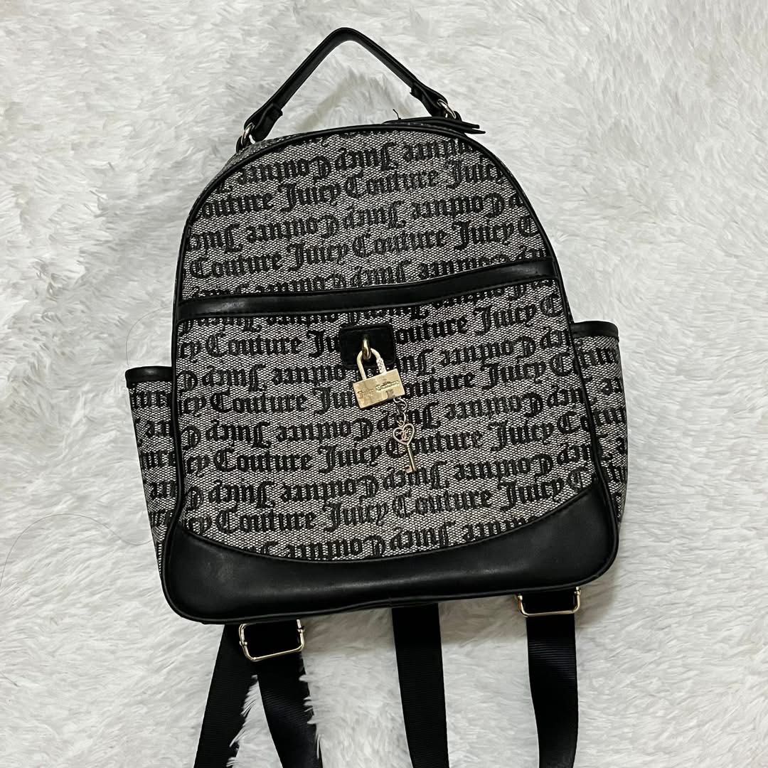 Juicy Couture Monogram Black & White Backpack (Category: Backpacks) located in Consolacion. Submitted by everythingispreloved_ (Listing ID 1466655244, Image 1). Description: - Authentic Juicy Couture black & white monogram backpack - Structured top handle and comfortable adjustable shoulder straps - Front flap pocket with secure padlock and key charm hardware - Smooth gold-tone zip closure for the main compartment - Convenient side slip pockets f