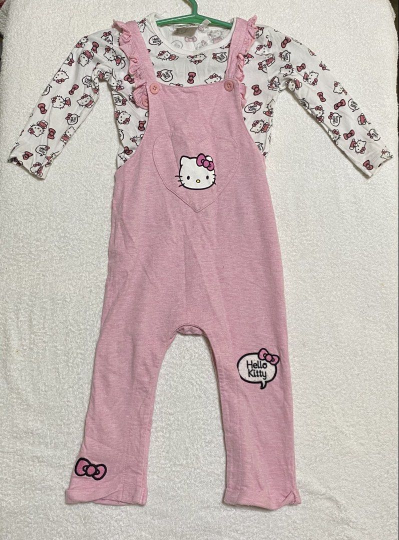 Jumpsuit with long sleeves (Category: Babies & Kids Fashion) located in Morong. Submitted by ladygjimenez0224 (Listing ID 1466665848, Image 1). Description: - Brand: Kitty - Type: Jumpsuit set with long sleeves - Size: 18-24 months - Color: Pink overall with white printed inner top - Features: Cute Kitty graphics, heart-shaped chest pocket, and ruffle shoulder straps - Condition: Good pre-loved condition, soft and comfortable fabric.