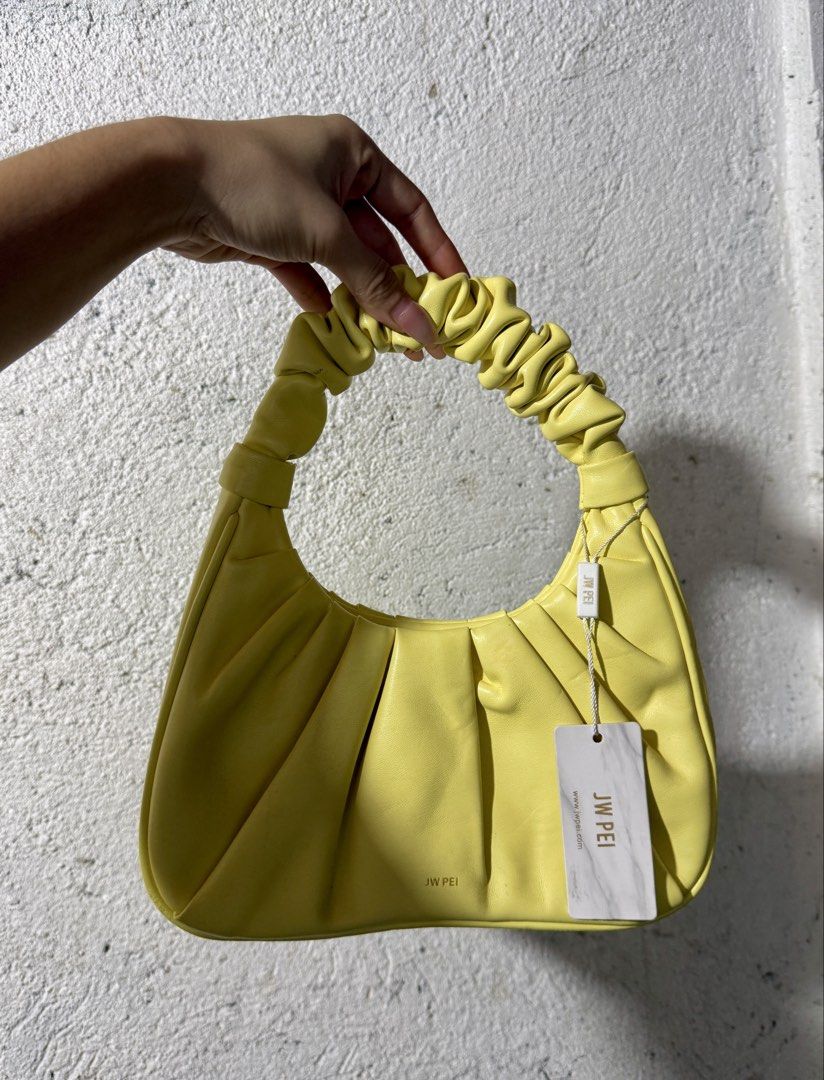 Jwei Bag (Category: Clutches) located in Abucay. Submitted by fastlion.584bdf (Listing ID 1466750186, Image 1). Description: - Brand: JW Pei - Color: Bright Yellow - Style: Shoulder bag / Handbag - Design: Trendy ruched handle with stylish pleated body - Ideal for casual outings, dates, and trendy OOTDs.