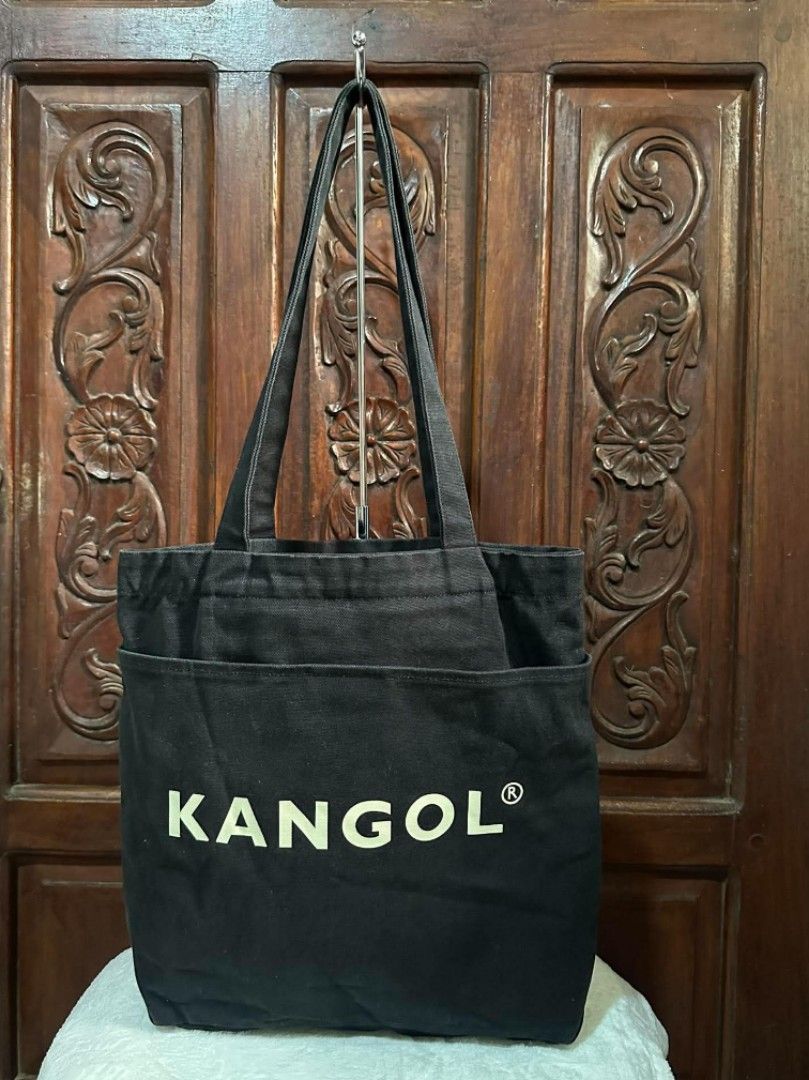 Kangol Black Canvas Tote Bag (Category: Tote Bags) located in Pasacao. Submitted by kishhuschka (Listing ID 1466650785, Image 2). Description: -Kangol black canvas tote bag (Est. 1938 British heritage) - 100% durable cotton material with clean interior tags and care labels - Features a striking large white kangaroo logo and KANGOL text on the front - Comfortable and sturdy shoulder straps for daily wear - Convenient outer pocket for easy-to-reach
