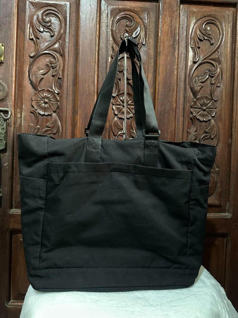 Kangol Black Tote Bag with Pockets (Category: Tote Bags) located in Pasacao. Submitted by kishhuschka (Listing ID 1466651541, Image 2). Description: - Kangol black canvas tote bag - Large main compartment fits books and a laptop - Front pocket with secure snap button closure - Convenient side pockets for quick access - Durable and sturdy black shoulder straps (Adjustable) - Classic embroidered Kangol logo on the front - 'Born British' side tag de