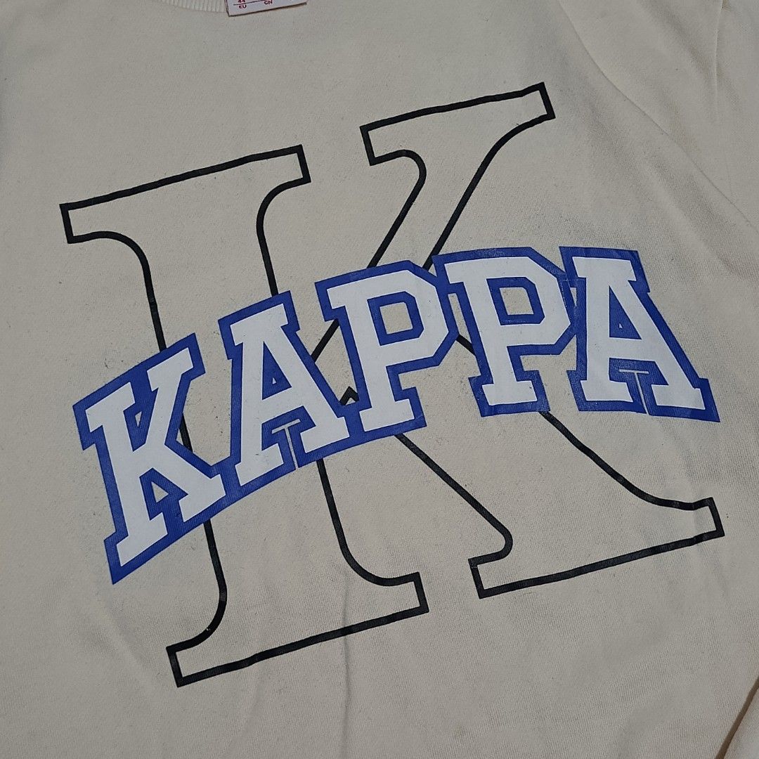 Kappa Collegiate Graphic Logo Sweatshirt (Category: Coats, Jackets and Outerwear) located in Bay. Submitted by ndrwthrift (Listing ID 1466764555, Image 3). Description: Kappa Collegiate Graphic Logo Sweatshirt Condition - 9/10 Size - Medium on tag Dimes - L 27" W 21" Color Rate - 9/10 Issue - Slight logo print cracks, washable stains *meet up or shipping via lalamove (buyer's expense) *can ship nationwide via j&t.