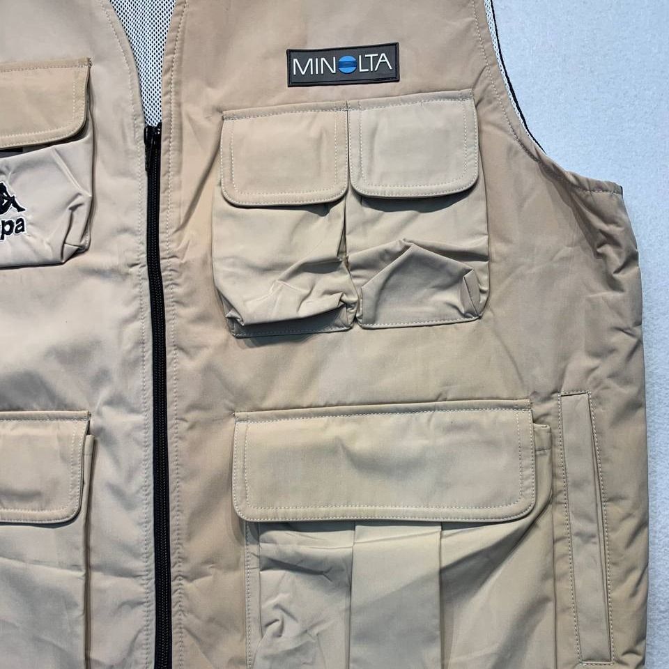 Kappa x Minolta Beige Utility Cargo Vest (Category: Vests) located in Mandaluyong City. Submitted by theroom501 (Listing ID 1466687068, Image 3). Description: Kappa x Minolta Beige Utility Cargo Vest Style Code: Size on Tag: Large Color: Cream Condition: Good pre-owned condition with a heavily distressed vintage look. Flaws/Issues: Discoloration and Crack print dust stain need wash. Flat Lay Measurements: Pit to Pit: 23 inches Length: 25.5 inches