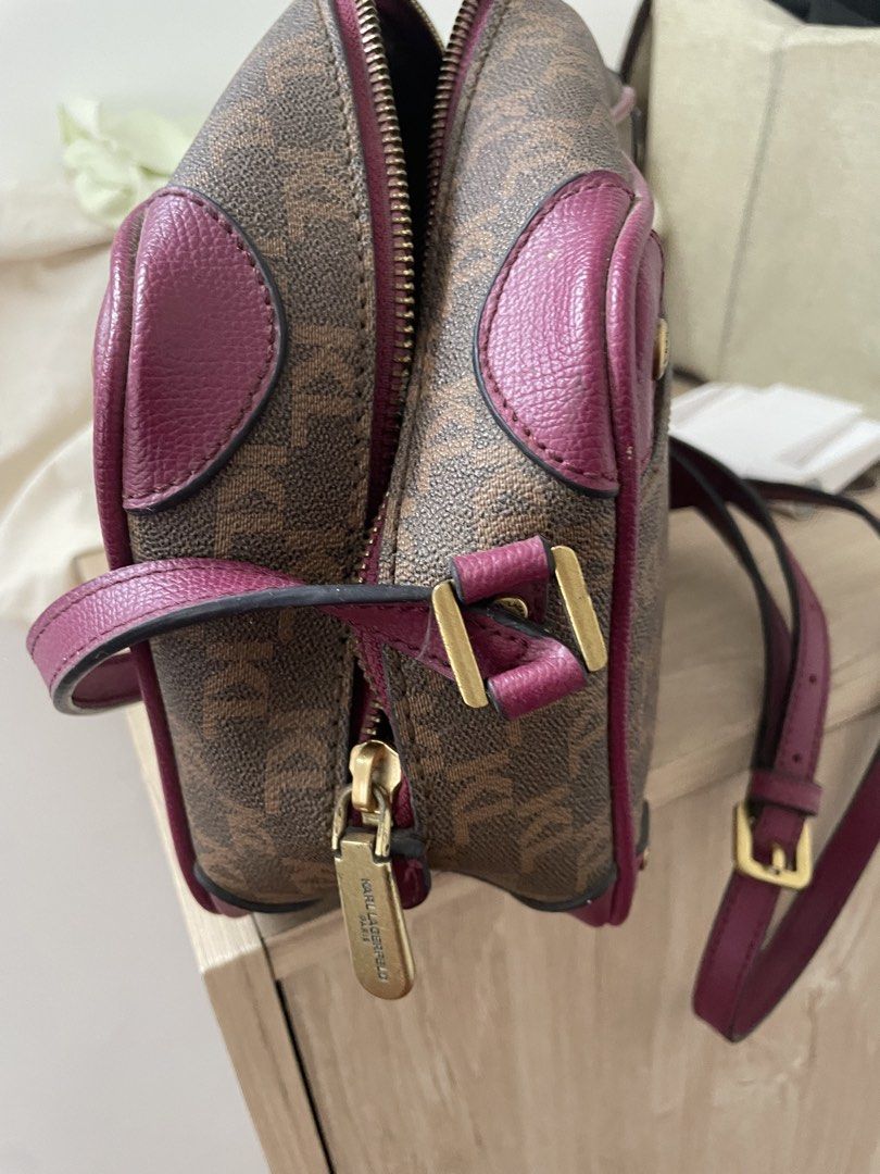 Karl Lagerfeld Monogram Crossbody Handbag (Category: Cross-body Bags) located in Cordova. Submitted by fiercedragon.47e450 (Listing ID 1466605014, Image 1). Description: - Brand: Karl Lagerfeld - Design: Classic brown monogram print with contrasting magenta pink trim and leather details - Hardware: Premium gold-toned hardware (zipper pull and adjustable shoulder strap buckle) - Interior: Patterned grey fabric lining with an internal zipped pocket